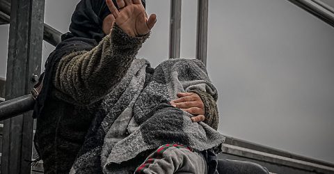 Syrian beggar with a baby in her arms