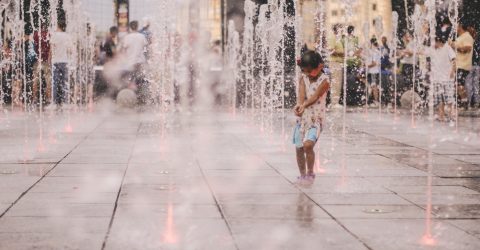 Girl play in the fountain