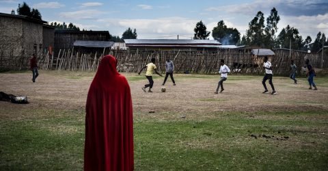 Woman watching football in Ethiopia