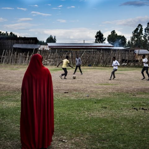 Woman watching football in Ethiopia