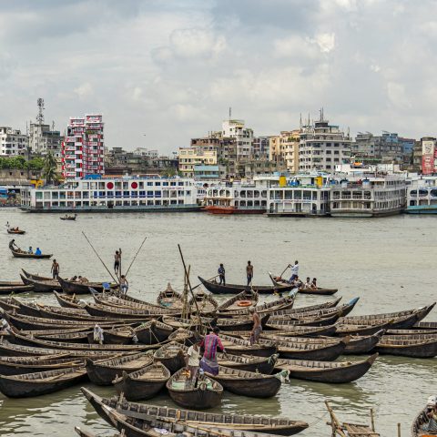 Aerial view of traditional boats docked at Old Dhaka river port along Buriganga shoreline river in Dhaka, Bangladesh.