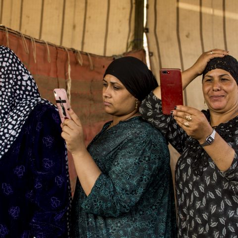 Three woman photograph a video for the people who dance on the anniversary of The Birth of Elsayed Albadwi