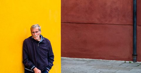 A man against yellow wall