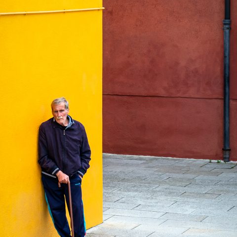 A man against yellow wall